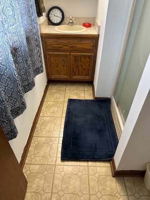 3806 Juniper Ave, Joliet, IL 60431 - bathroom featuring vanity, a shower with door, and baseboards