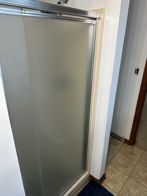 3806 Juniper Ave, Joliet, IL 60431 - full bathroom featuring a stall shower and baseboards