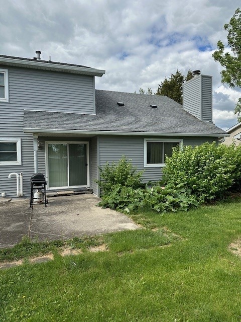 3806 Juniper Ave, Joliet, IL 60431 - back of house with a patio, a lawn, and a chimney