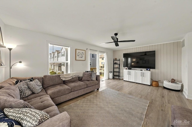 2451 Alison Ave, Pingree Grove, IL 60140 - living room featuring light wood-style floors, ceiling fan, and wood walls