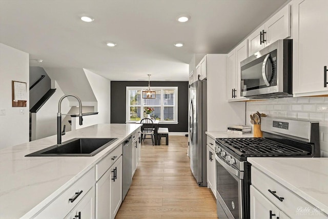 2451 Alison Ave, Pingree Grove, IL 60140 - kitchen featuring appliances with stainless steel finishes, a sink, white cabinets, light wood-style flooring, and recessed lighting
