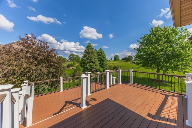 wooden terrace featuring a yard