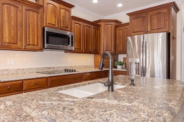 kitchen with stainless steel appliances, a sink, light stone countertops, recessed lighting, and tasteful backsplash