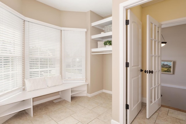 mudroom with tile patterned floors and baseboards