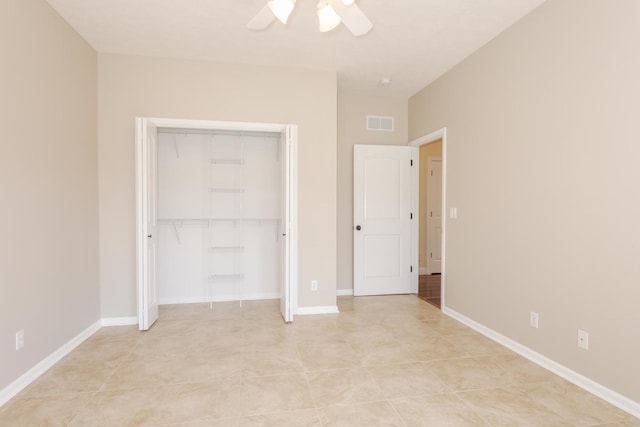 unfurnished bedroom featuring a closet, ceiling fan, light tile patterned flooring, and baseboards