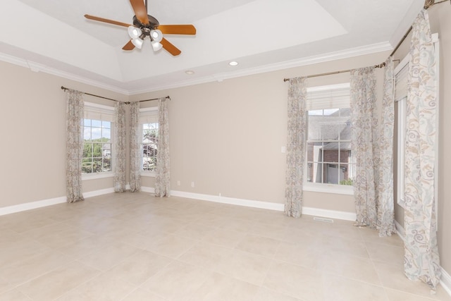 tiled empty room with a ceiling fan, ornamental molding, a tray ceiling, recessed lighting, and baseboards