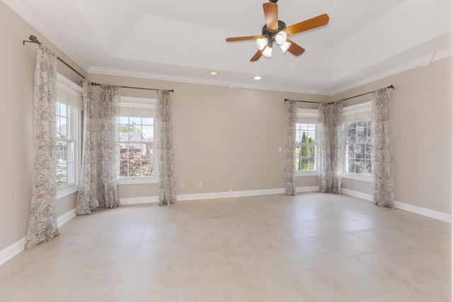 empty room featuring ceiling fan, a tray ceiling, crown molding, light tile patterned flooring, and baseboards