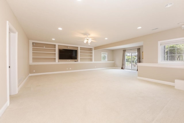 empty room with light colored carpet, baseboards, recessed lighting, a ceiling fan, and built in shelves
