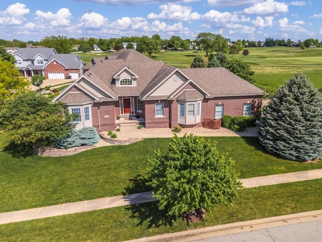 view of front of house with brick siding and a front lawn