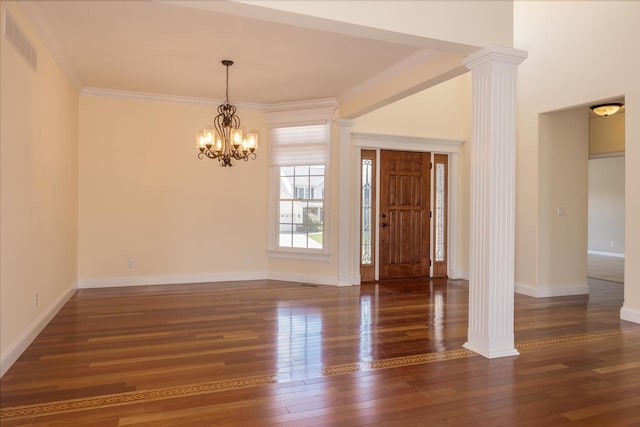 entrance foyer with wood-type flooring, decorative columns, a chandelier, baseboards, and crown molding
