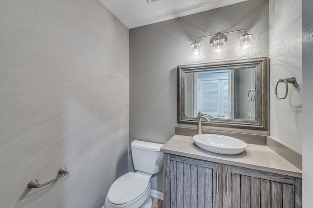 half bathroom featuring toilet and vanity