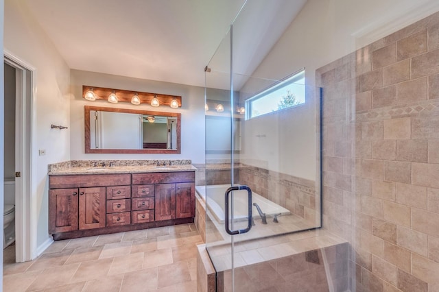 full bathroom with a stall shower, double vanity, toilet, and vaulted ceiling