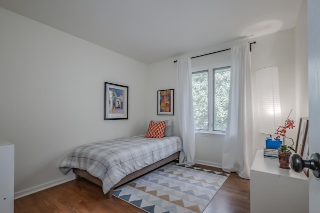 bedroom with wood finished floors and baseboards