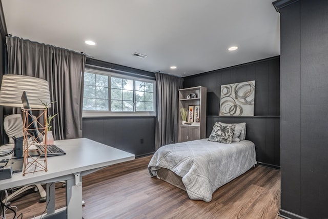 bedroom featuring wood finished floors, recessed lighting, and an office area