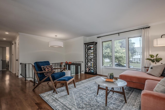 living room featuring crown molding, dark wood-style floors, and baseboards