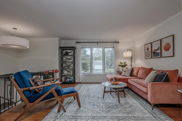 living area with ornamental molding and wood finished floors