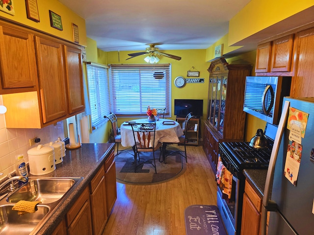 760 Mendocino Ct Unit 5, University Park, IL 60484 - kitchen with appliances with stainless steel finishes, a sink, light wood finished floors, brown cabinets, and a ceiling fan