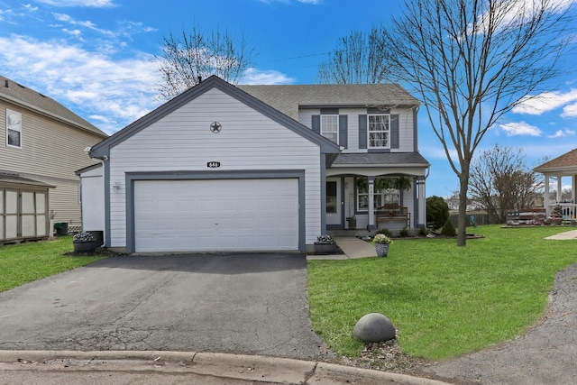 646 E Weston Ct, Round Lake Beach, IL 60073 - traditional home featuring asphalt driveway, covered porch, a front yard, a garage, and roof with shingles