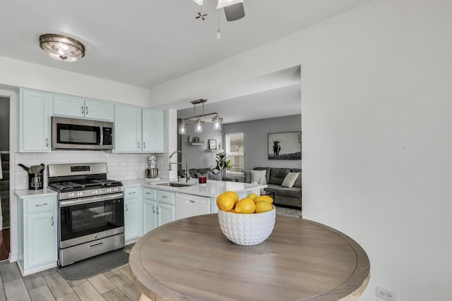 646 E Weston Ct, Round Lake Beach, IL 60073 - kitchen featuring stainless steel appliances, a sink, light countertops, and decorative backsplash