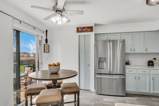 646 E Weston Ct, Round Lake Beach, IL 60073 - kitchen with stainless steel fridge, tasteful backsplash, ceiling fan, light countertops, and light wood-style floors