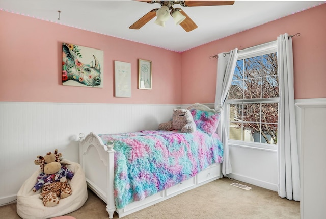 646 E Weston Ct, Round Lake Beach, IL 60073 - bedroom featuring carpet flooring, a wainscoted wall, and a ceiling fan