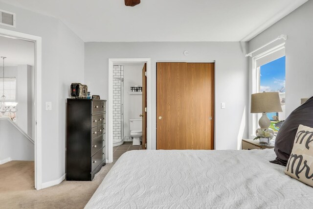 646 E Weston Ct, Round Lake Beach, IL 60073 - bedroom featuring a chandelier, light carpet, ensuite bath, and baseboards