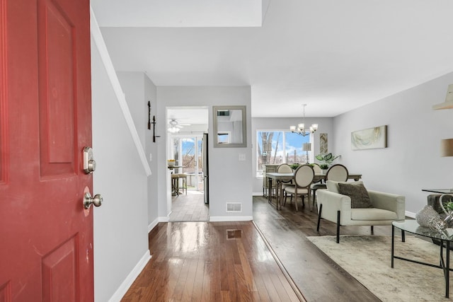 646 E Weston Ct, Round Lake Beach, IL 60073 - entrance foyer with dark wood-type flooring, baseboards, and a chandelier