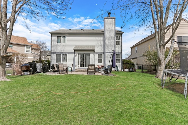 646 E Weston Ct, Round Lake Beach, IL 60073 - rear view of house with a trampoline, a chimney, a patio, and entry steps