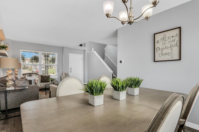 646 E Weston Ct, Round Lake Beach, IL 60073 - dining area with a chandelier, dark wood-style flooring, and stairway