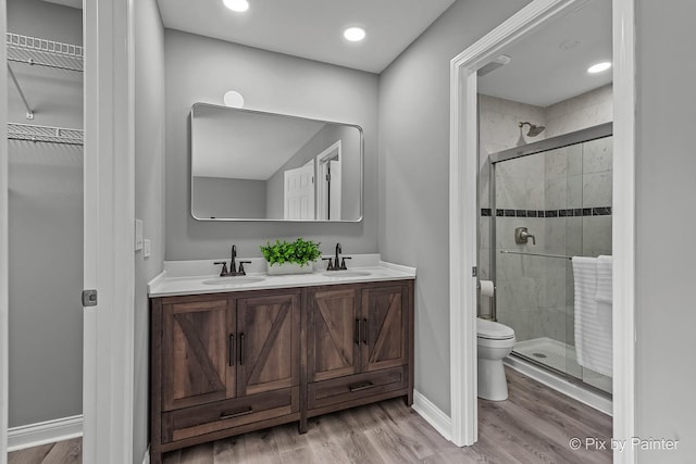 1140 Division St, Geneva, IL 60134 - bathroom with a shower stall, wood finished floors, toilet, and recessed lighting