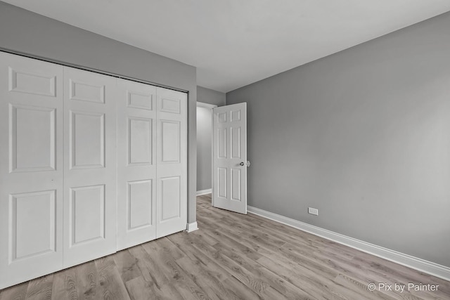 1140 Division St, Geneva, IL 60134 - unfurnished bedroom featuring wood finished floors, baseboards, and a closet