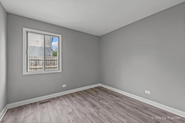 1140 Division St, Geneva, IL 60134 - spare room featuring wood finished floors and baseboards
