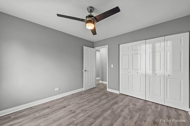 1140 Division St, Geneva, IL 60134 - unfurnished bedroom featuring wood finished floors, baseboards, a closet, and a ceiling fan