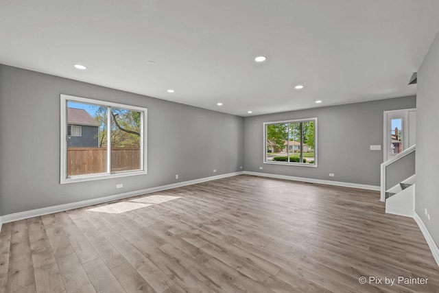 1140 Division St, Geneva, IL 60134 - empty room with wood finished floors, baseboards, recessed lighting, and stairs
