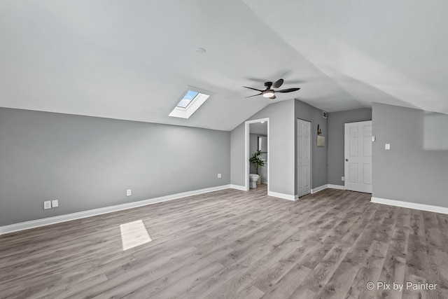 1140 Division St, Geneva, IL 60134 - additional living space featuring a ceiling fan, a skylight, wood finished floors, lofted ceiling, and baseboards