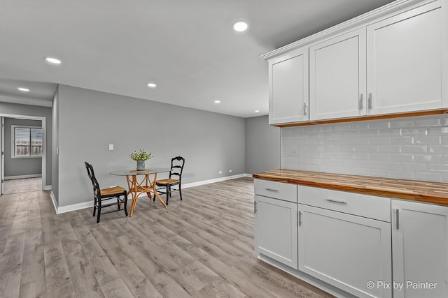 1140 Division St, Geneva, IL 60134 - kitchen with wooden counters, decorative backsplash, baseboards, white cabinets, and recessed lighting
