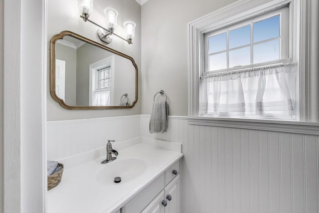 bathroom featuring wainscoting, vanity, and ornamental molding