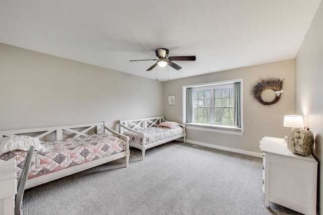bedroom with carpet flooring, baseboards, and a ceiling fan