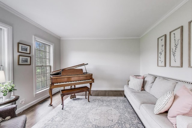 living room featuring plenty of natural light, wood finished floors, ornamental molding, and baseboards