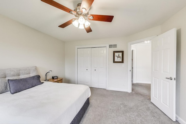 bedroom featuring carpet flooring, baseboards, a closet, and a ceiling fan