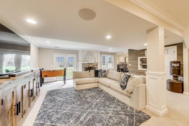 living room featuring light carpet, crown molding, recessed lighting, and a fireplace