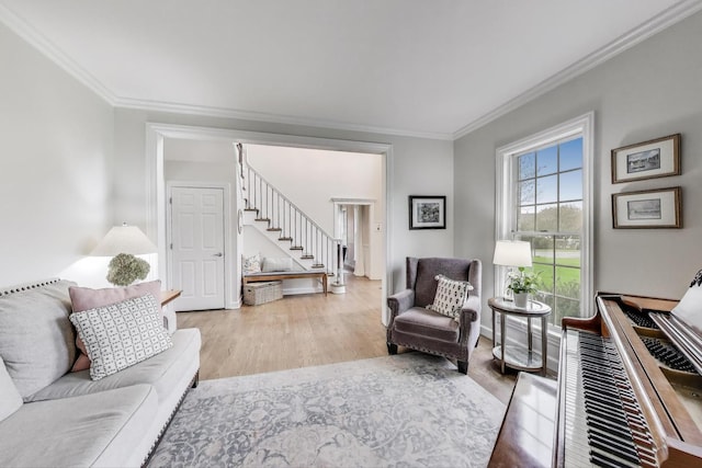 living room featuring stairs, ornamental molding, and wood finished floors