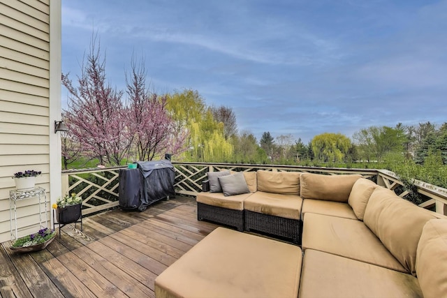 wooden terrace featuring an outdoor hangout area and grilling area
