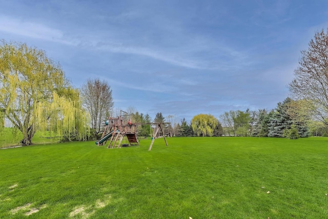 view of grassy yard featuring a playground