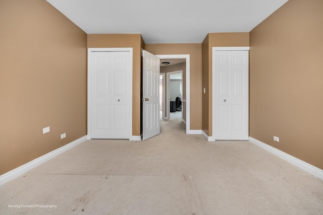 1770 Oxford Dr, Mundelein, IL 60060 - unfurnished bedroom featuring multiple closets, light colored carpet, and baseboards