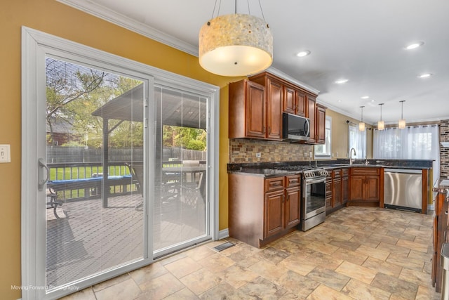 1770 Oxford Dr, Mundelein, IL 60060 - kitchen featuring appliances with stainless steel finishes, crown molding, stone tile floors, decorative backsplash, and recessed lighting