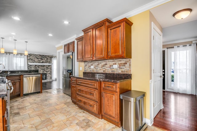 1770 Oxford Dr, Mundelein, IL 60060 - kitchen featuring appliances with stainless steel finishes, tasteful backsplash, brown cabinets, ornamental molding, and a sink