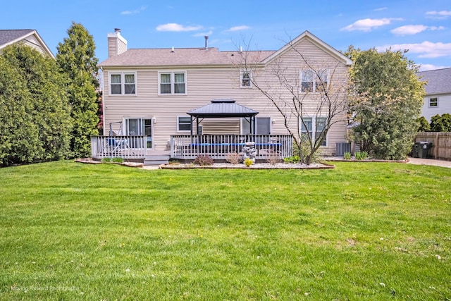 1770 Oxford Dr, Mundelein, IL 60060 - rear view of house with a gazebo, a chimney, a lawn, and central AC