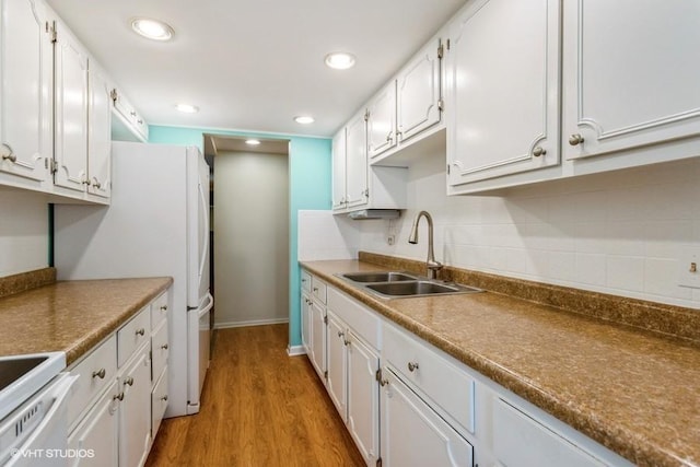 2900 Maple Ave Unit 13D, Downers Grove, IL 60515 - kitchen with a sink, white cabinetry, range, light wood-style floors, and tasteful backsplash