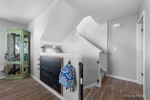 additional living space featuring wood finished floors and baseboards